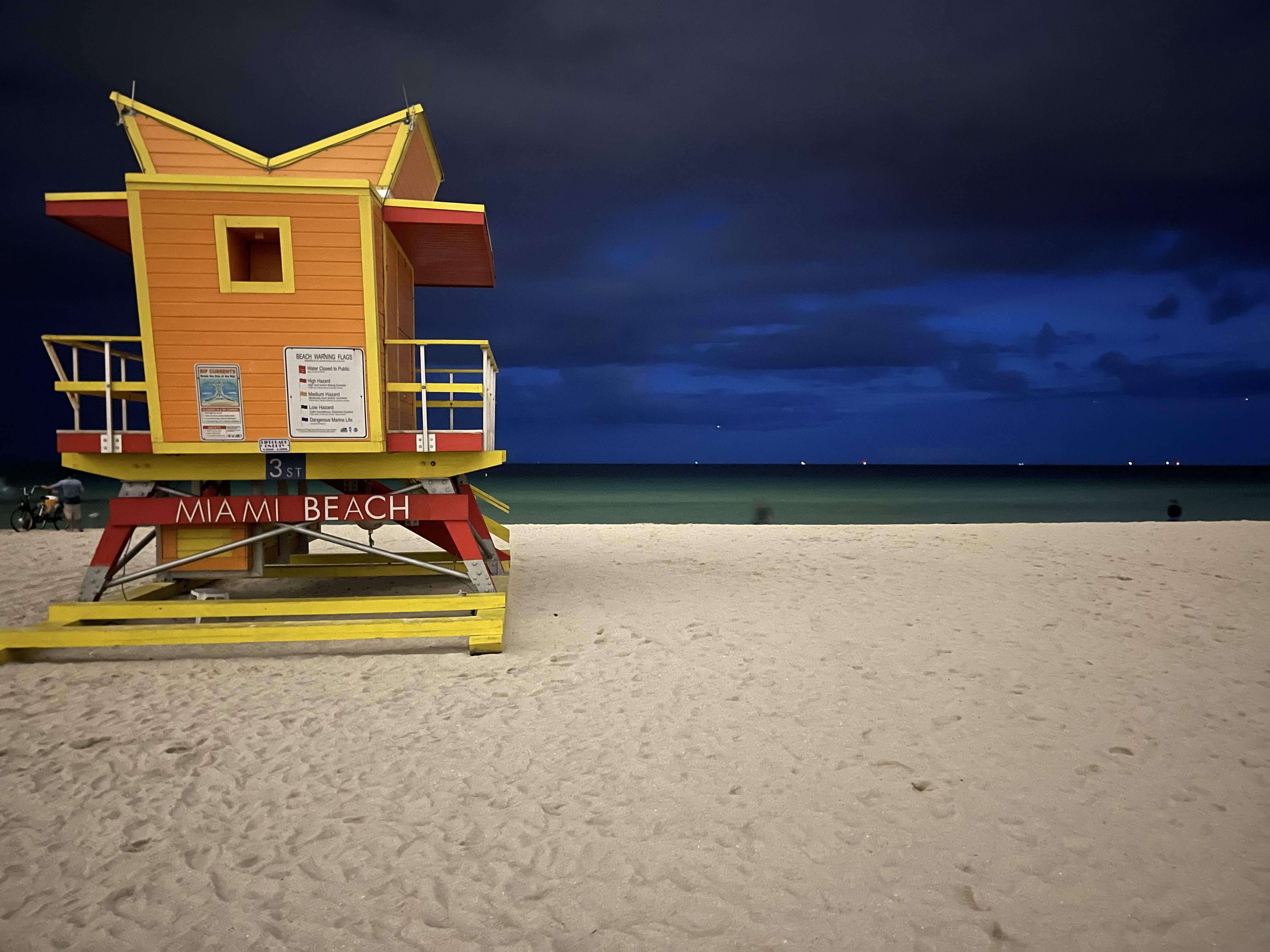 Iconic lifeguard stand at dusk along the South of Fifth beachfront with warm sunset colors