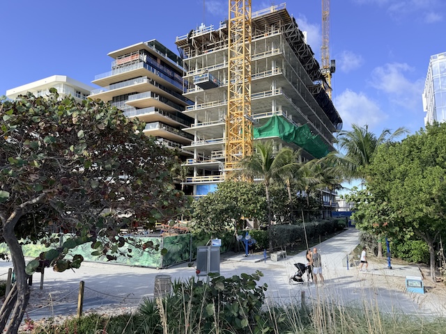 Surfside beachfront new construction site with ocean access path and tropical landscaping